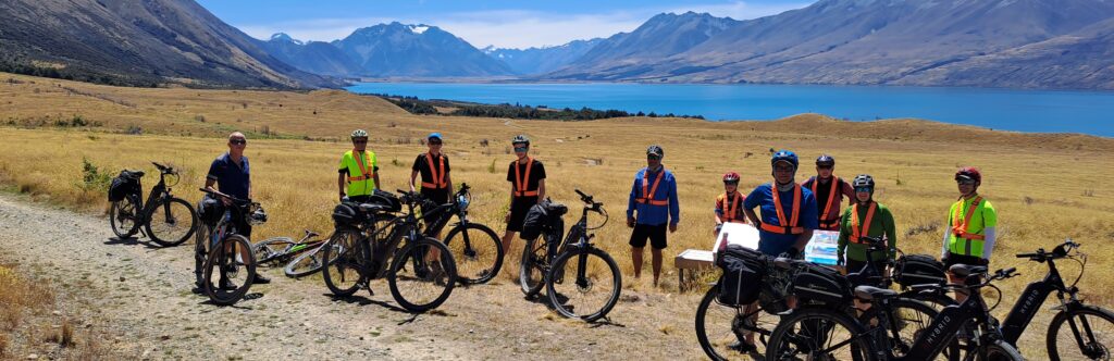 cyclists stopping by a lake on the alps to Ocean track