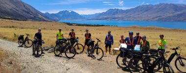 cyclists stopping by a lake on the alps to Ocean track