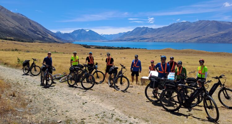 cyclists stopping by a lake on the alps to Ocean track