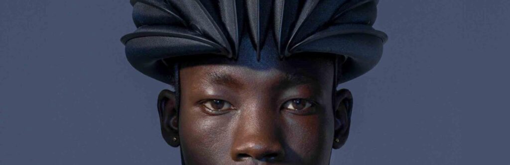 man with inflatable folding bike helmet
