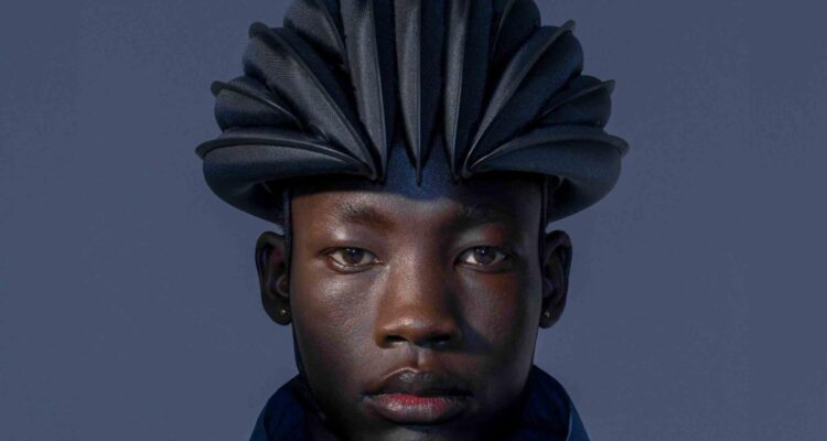 man with inflatable folding bike helmet